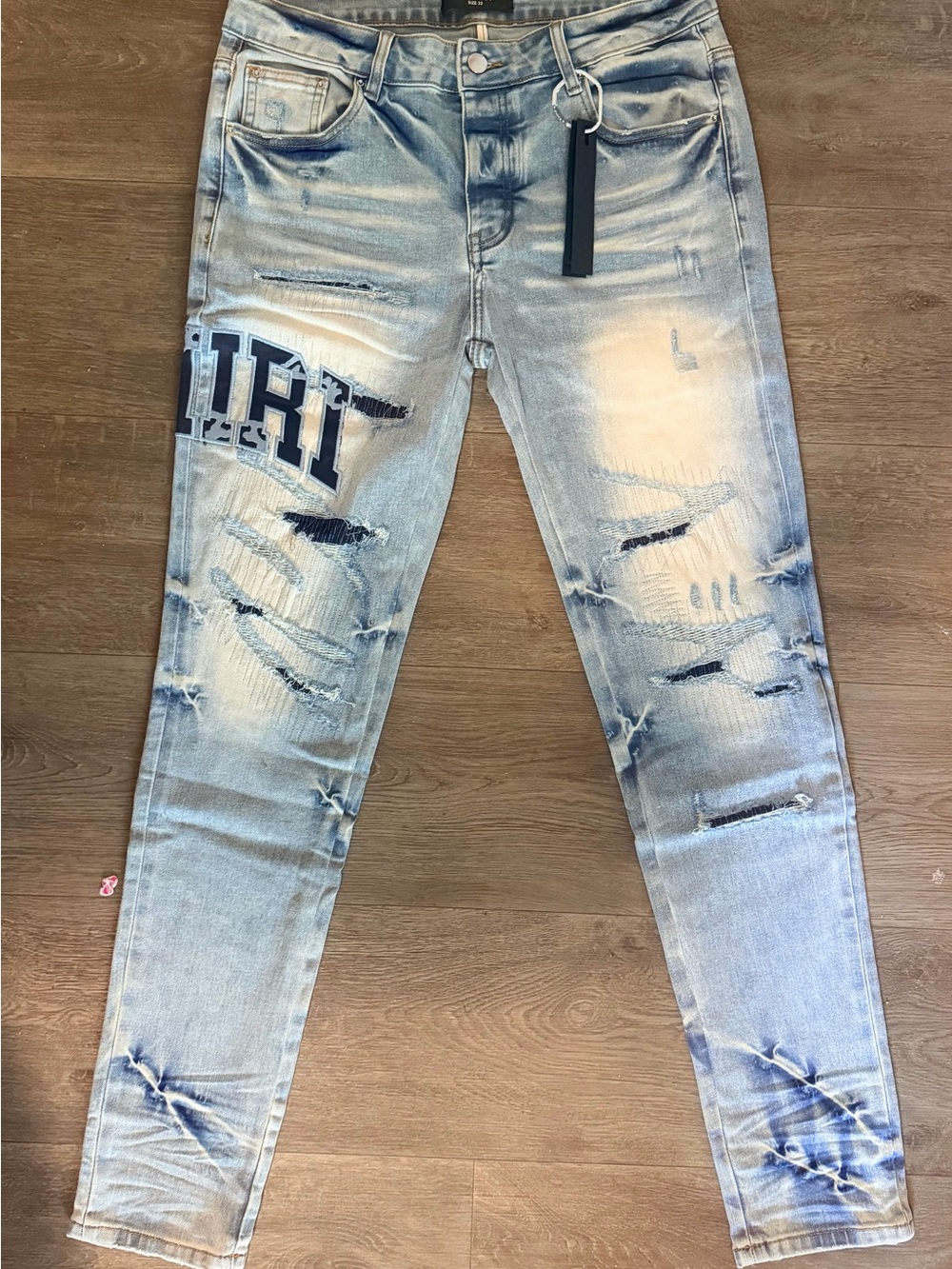 AMIRI Light Blue Distressed Skinny Jeans with Logo Patch